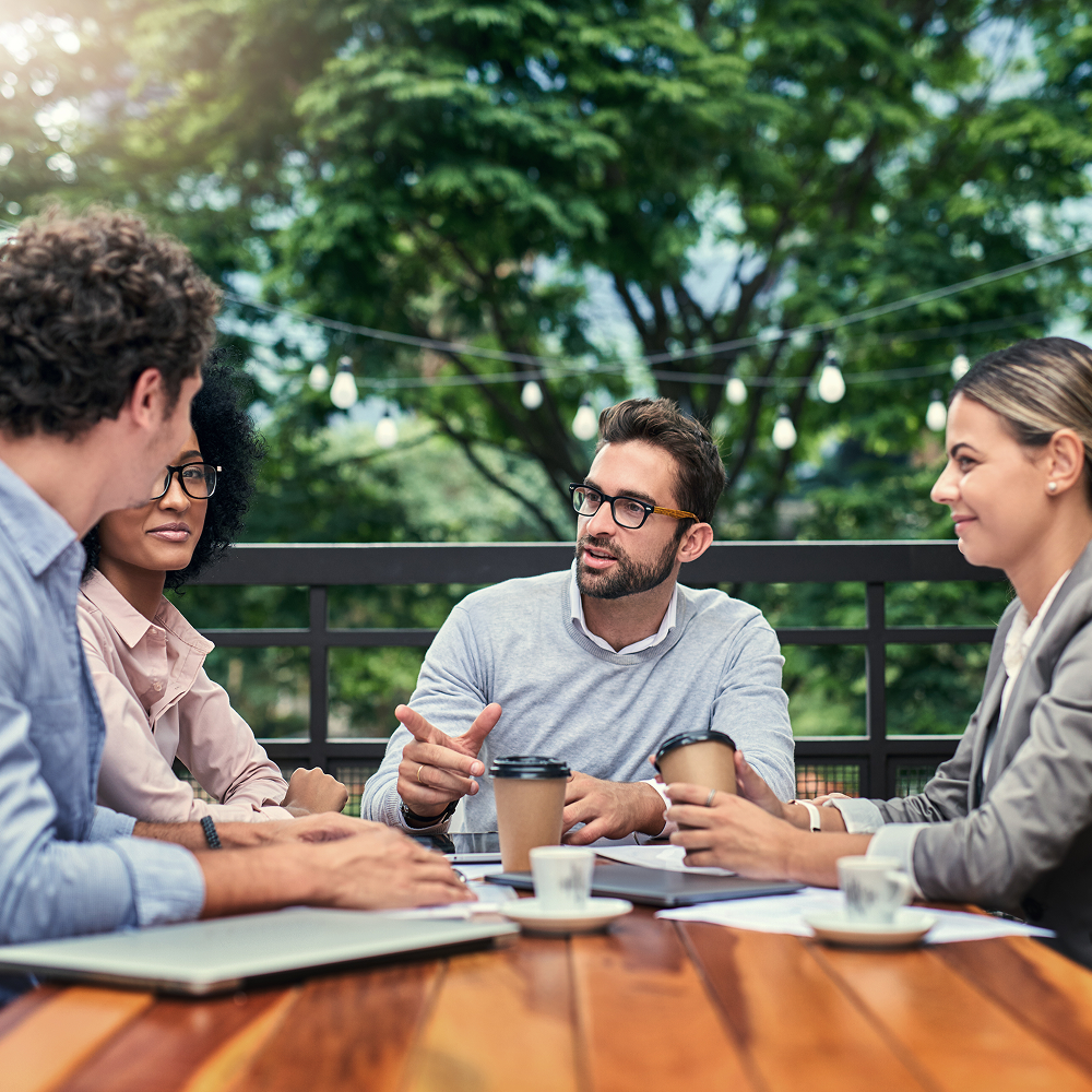 Co-workers having a meeting outside.